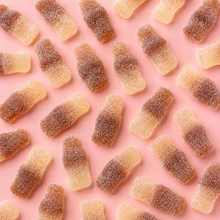 Overhead arrangement of Fizzy Cola Bottles sweets