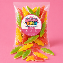 Gummy Crocodiles Sugar Rush bag with sweets on pink background