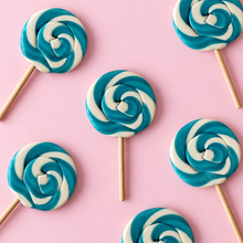 Overhead arrangement of Blue Swirl Lollipops on a pale pink background
