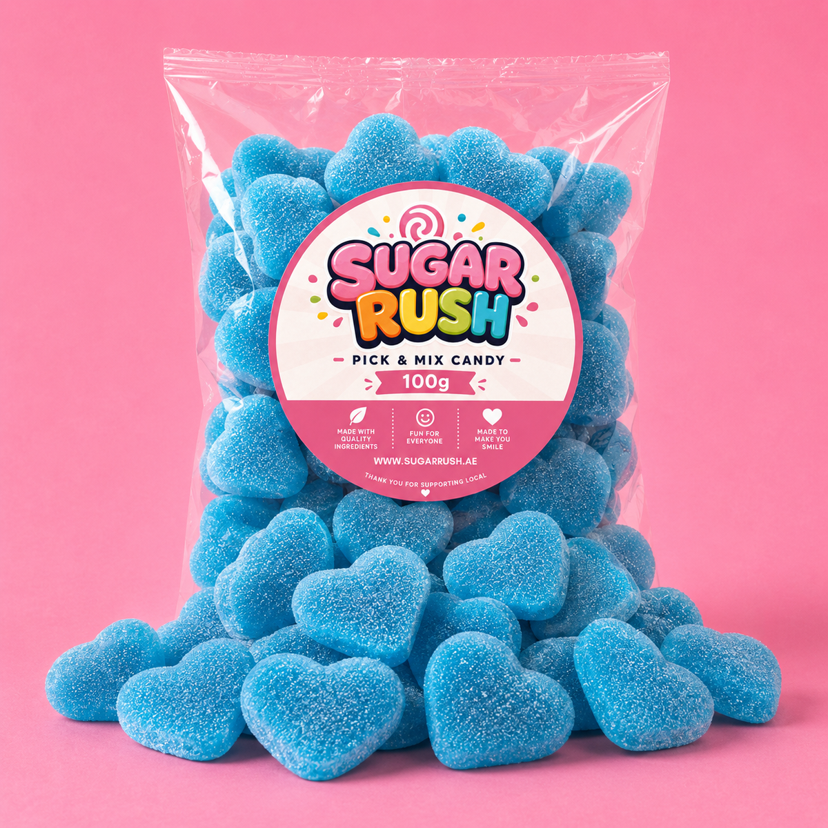 Blue Filled Hearts Sugar Rush bag with sweets on pink background