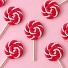 Overhead arrangement of Pink Swirl Lollipops on a pale pink background