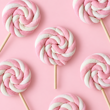 Overhead arrangement of pink and white Marshmallow Lollipops on a pale pink background