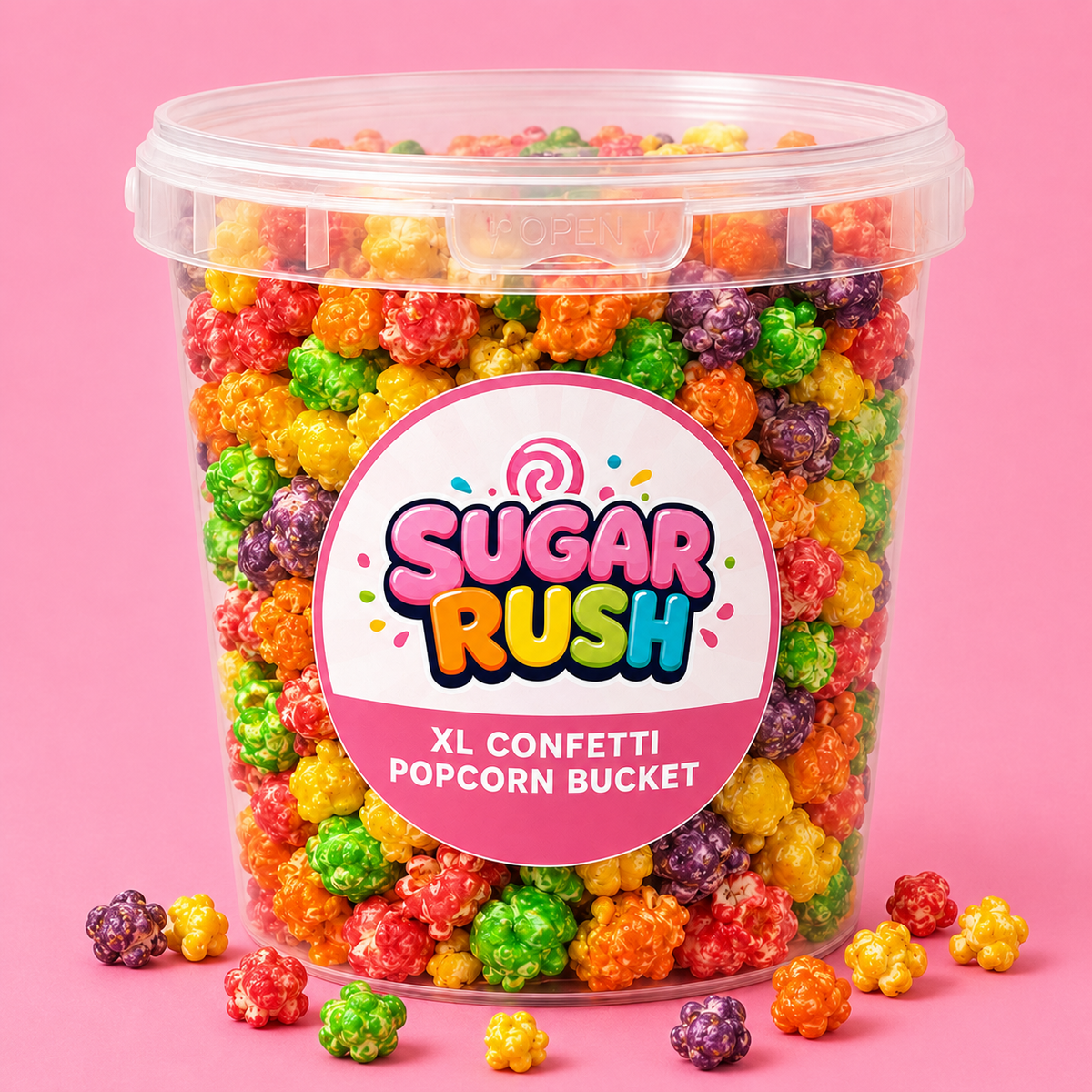 Sugar Rush XL Confetti Popcorn Bucket on a bright pink background with popcorn scattered in front