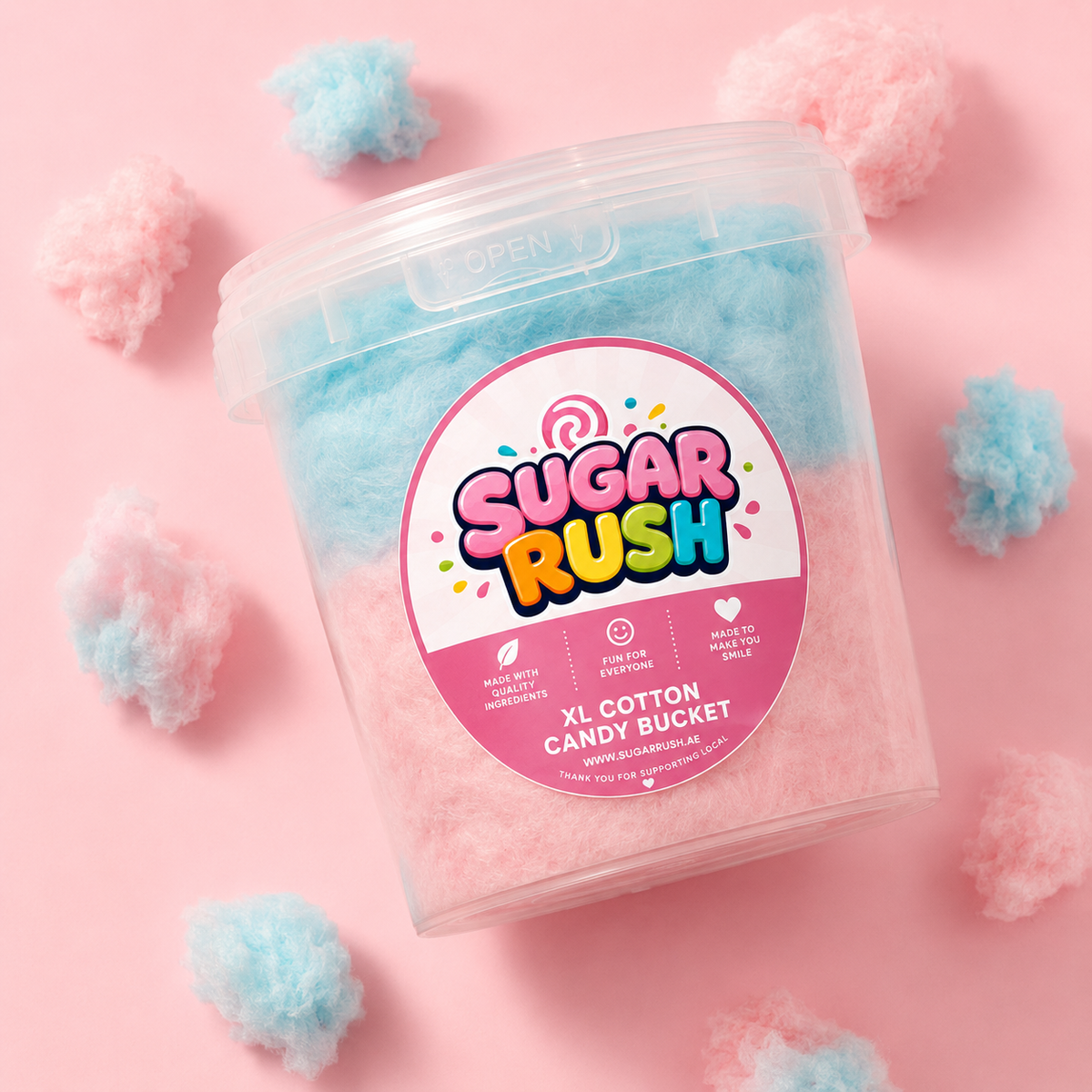 Sugar Rush XL Cotton Candy Mixed Bucket on a bright pink background with loose cotton candy